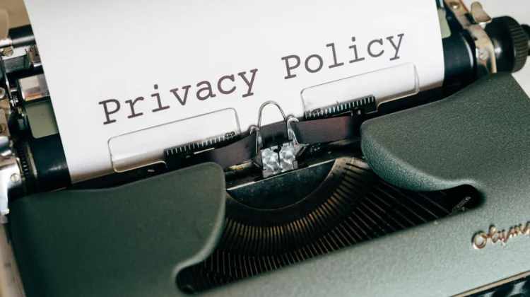 Close-up of a vintage typewriter featuring a privacy policy document in focus, highlighting classic technology.