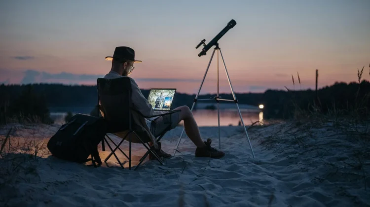 A person working on a laptop with a map of South Africa.